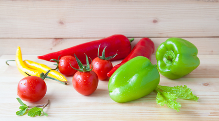 Variety of fresh appetizing vegetables on wooden tableの写真素材