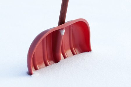 Closeup of a red shovel for snow removalの写真素材