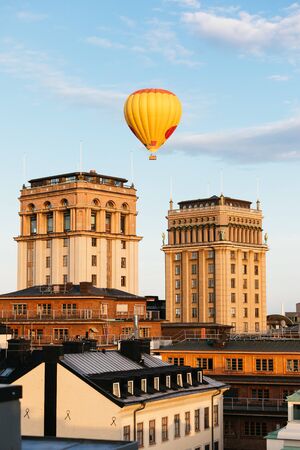 Amazing touristic view on the Kungstornen in Stockholm, with aerostat in the gentle evening sky during the sunsetの写真素材