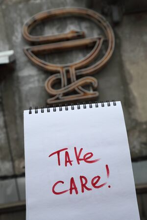 Handwritten text Take care on a paperの写真素材