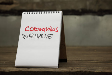 Coronavirus quarantine. Text written by hand on a paper