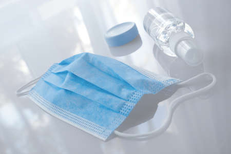 Mask and hand sanitizer on the white backgroundの写真素材
