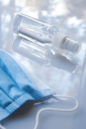 Mask and hand sanitizer on the white backgroundの写真素材