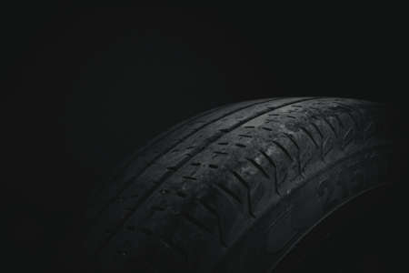 Tire from a car type truck on a black and white background with a vignette around the edgesの写真素材