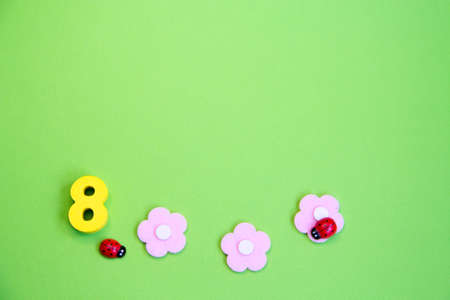 Pink flowers and an eight on a green background, a place for text.Spring greenの写真素材
