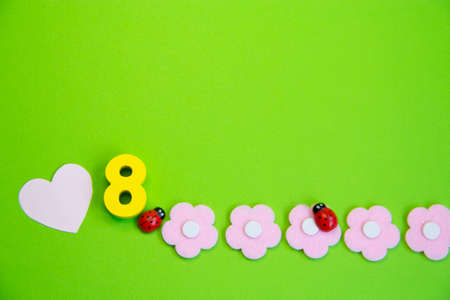 Pink flowers and an eight on a green background, a place for text.Spring greenの写真素材