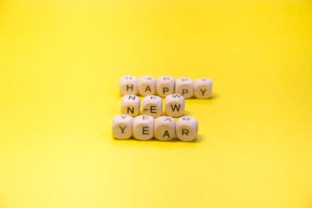 New Years layout on a yellow background, mittens, skates, with Wooden inscription Happy New Yearの写真素材