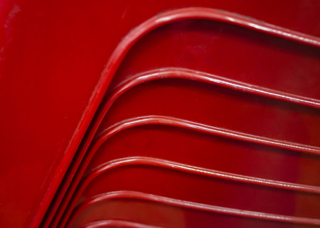 Bends of handles of chairs from cafes put one on otherの写真素材