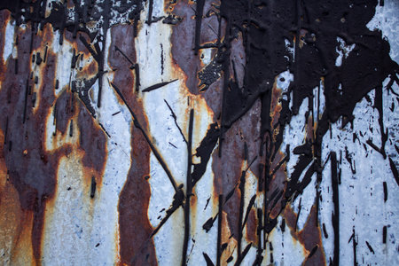 Old zincked ferrous sheet with a blight and Ð¿Ð¾Ñ‚ÐµÐºÐ°Ð¼Ð¸ of petroleum tar