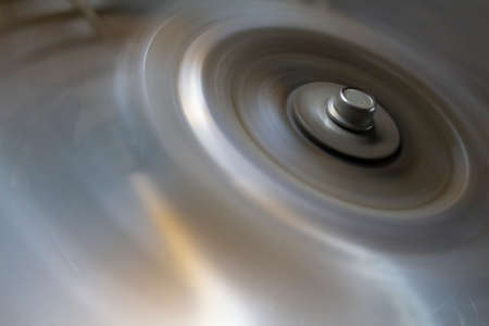 circle with a bolt head on the metal blades of a rotating fanの写真素材