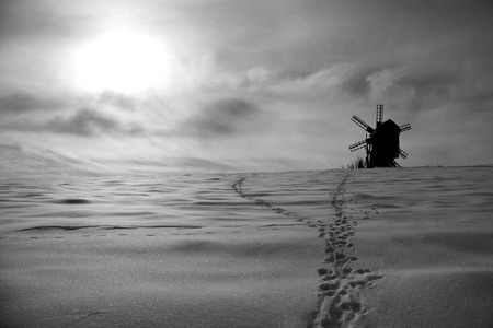 Beautiful winter windmill landscape in black and whiteの写真素材