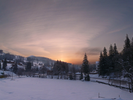sunset in a winter snowbound hillsの写真素材