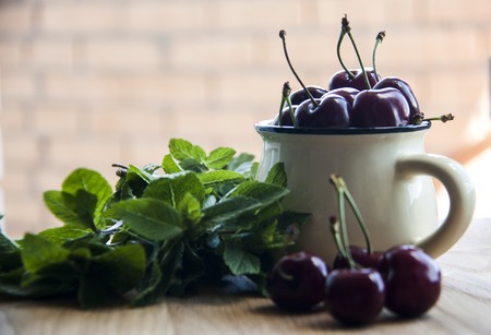 cherry in cup on woodの写真素材