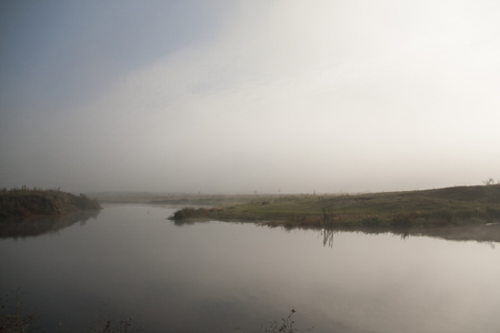 The river covered with fog in the morningの写真素材