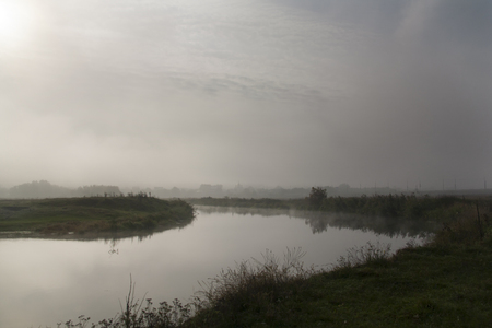 The river covered with fog in the morningの写真素材