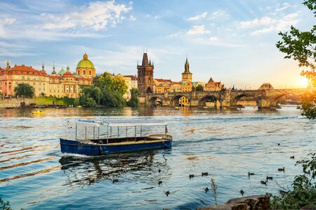 Charles Bridge on river Vltava in Prague at sunsetの写真素材