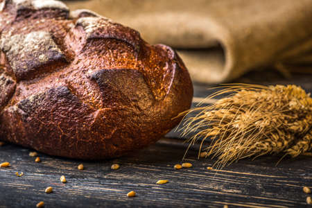 Fresh rye bread on old wooden tableの写真素材
