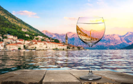 A glass of wine with in Perast town viewの写真素材