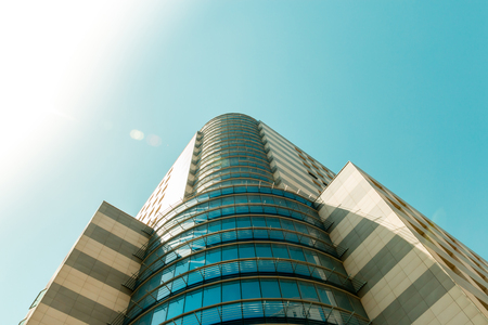 Top of huge business building from bottom view with solid skyの写真素材