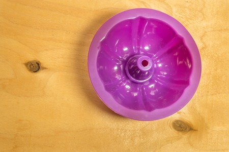 Purple silicone baking cups for muffins or cupcakes on solid wood background. Top view.の写真素材