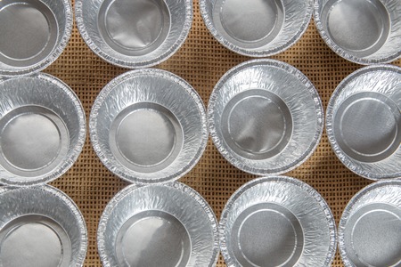 Group of Aluminium cupcake mold on wooden board.の写真素材