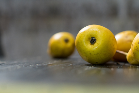 Group of ripe pears on dark rustic wooden table. Side view horizontal shot. Empty copyspace for your design.の写真素材