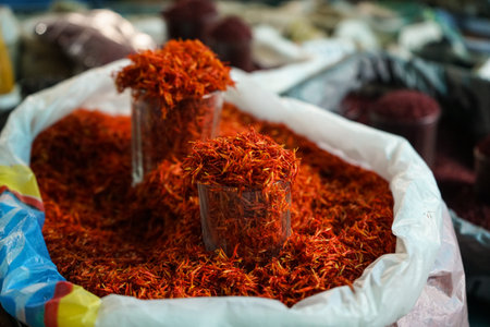 Saffron at bazar in sacks and measure glass cup. Close up shot.