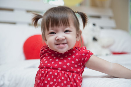 Beautiful baby girl wearing red smiling a happy smile