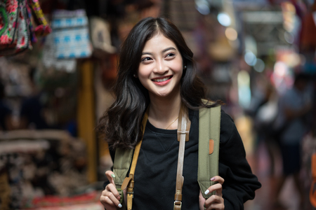 Happy young adult woman smiling with teeth smile outdoors and walking on city street of Bangkok City, Thailand, Concept Travelの写真素材