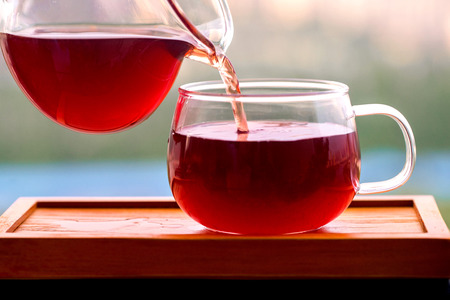 Pouring tea into a cupの写真素材