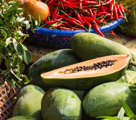 ripe papaya and red pepper on the marketの写真素材
