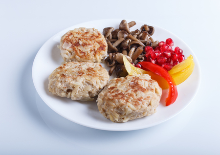 meatballs with rice mushrooms, sweet peppers and pomegranate seeds isolated on white background. close up.の写真素材