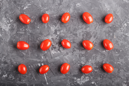 Rows of cherry tomatoes on a black concreteの写真素材