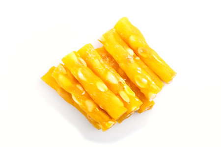yellow traditional turkish delight (rahat lokum) with peanuts isolated on white background. top view, flat lay, close up.の写真素材