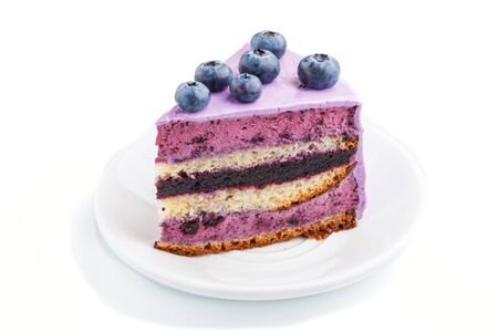 Homemade cake with souffle cream and blueberry jam isolated on white background. side view.の写真素材