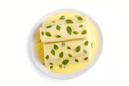Cannelloni pasta with egg sauce, cream cheese and oregano leaves isolated on white background. top view, flat lay, close up.の写真素材