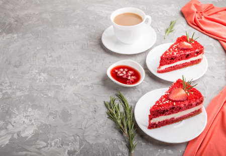Homemade red velvet cake with milk cream and strawberry with cup of coffee on a gray concrete...