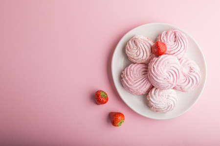 Pink strawberry homemade zephyr or marshmallow on pastel pink background. top view, flat lay, copy space.の写真素材