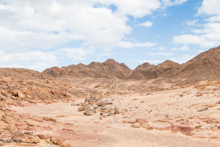 Desert, red mountains, rocks and cloudy sky. Egypt, color canyon, the Sinai Peninsula, Dahab.
