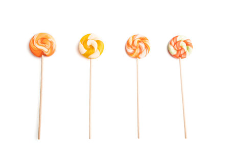 Four lollipop candies isolated on white background. close up, top view, flat lay.の写真素材