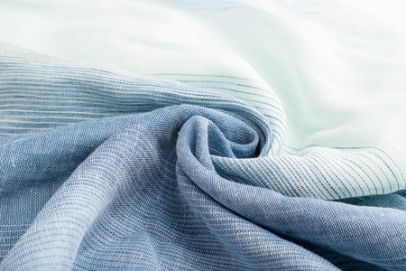 Fragment of blue linen tissue. Side view, natural textile background and texture. wave concept,...