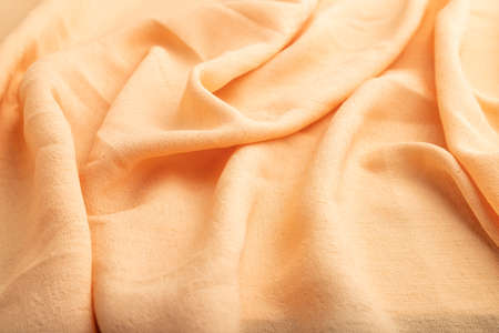 Fragment of orange linen tissue. Side view, natural textile background and texture. wave concept, abstract.の写真素材