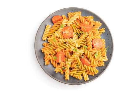 Tortiglioni semolina pasta with tomato and microgreen sprouts isolated on white background. Top view, flat lay, close up.の写真素材