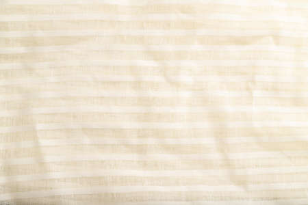 Fragment of smooth white linen tissue. Top view, flat lay, natural textile background and texture.の写真素材