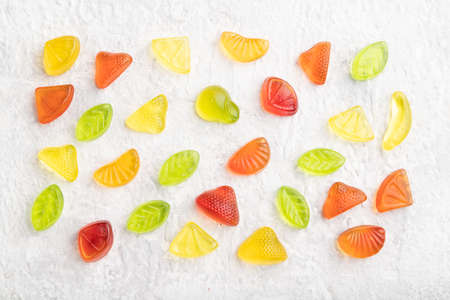 Various fruit jelly candies on gray concrete background. top view, flat lay, close up.の写真素材