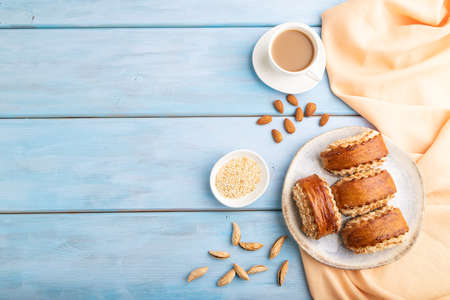Traditional armenian dessert gata with cup of coffee on a blue wooden background and orange linen textile. top view, flat lay, copy space.の写真素材