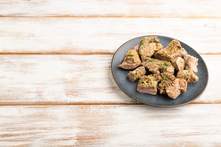 Stewed turkey fillet with garlic on white wooden background. Side view, copy space.の写真素材
