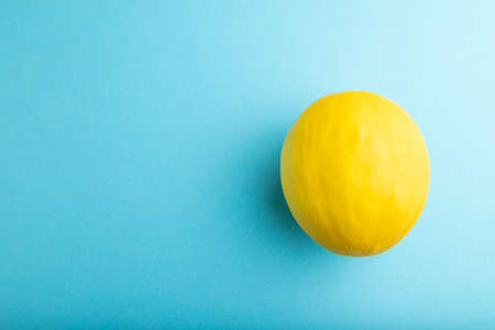 Ripe yellow melon on blue pastel background. Top view, flat lay, copy space. harvest, healthy, vegan food, concept, minimalism.の写真素材