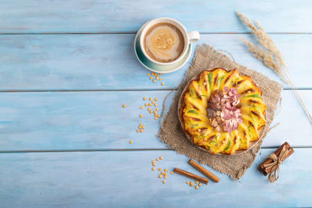 Cheesecake with cup of coffee on blue wooden background and linen textile. top view, flat lay, copy space.の写真素材