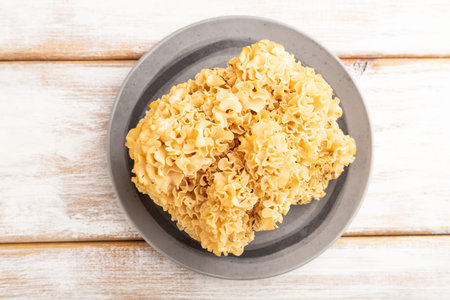 Raw Sparassis (Cauliflower Mushroom) on white wooden background. Top view, flat lay, close up.の写真素材